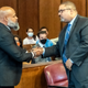 Steven Lopez, left, shake hands with Manhattan District Attorney Alvin Bragg, right, during a court hearing, Monday, July 25, 2022, in New York. Lopez, a co-defendant of the so-called Central Park Five, whose convictions in a notorious 1989 rape of a jogger were thrown out more than a decade later, had his conviction on a related charge overturned Monday.